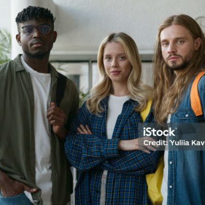 Portrait university college academy studying together education three students multiracial friendship multiethnic friends male men Caucasian African American guys woman girl female looking at camera. High quality 4k footage